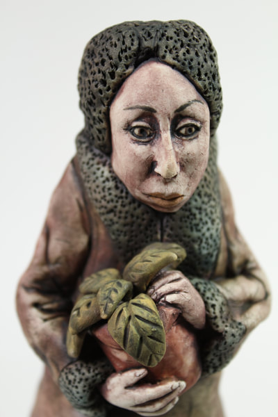 Porcelain Figure of a Woman holding a Plant