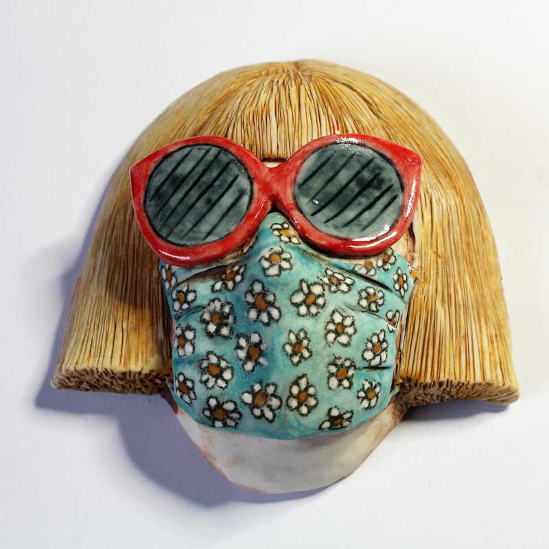 Woman wearing sunglasses and facemask